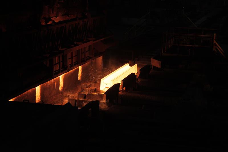 Photo of hot Nucor steel beam rolling down manufacturing line