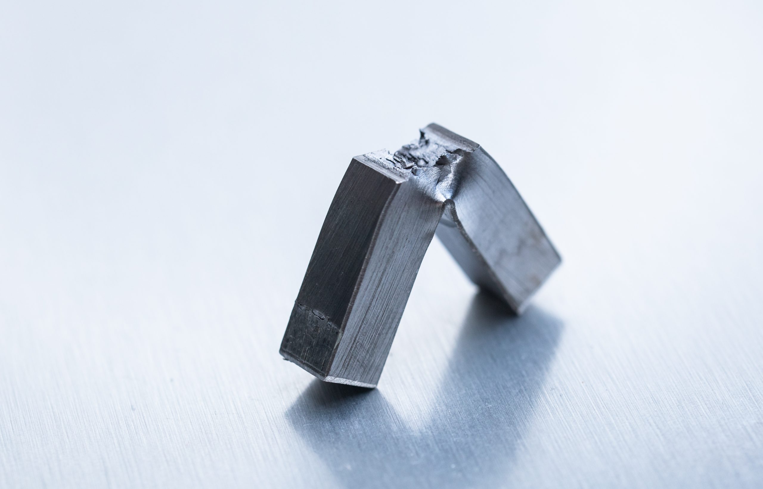 Image showing a piece of steel split by the Charpy V-notch test