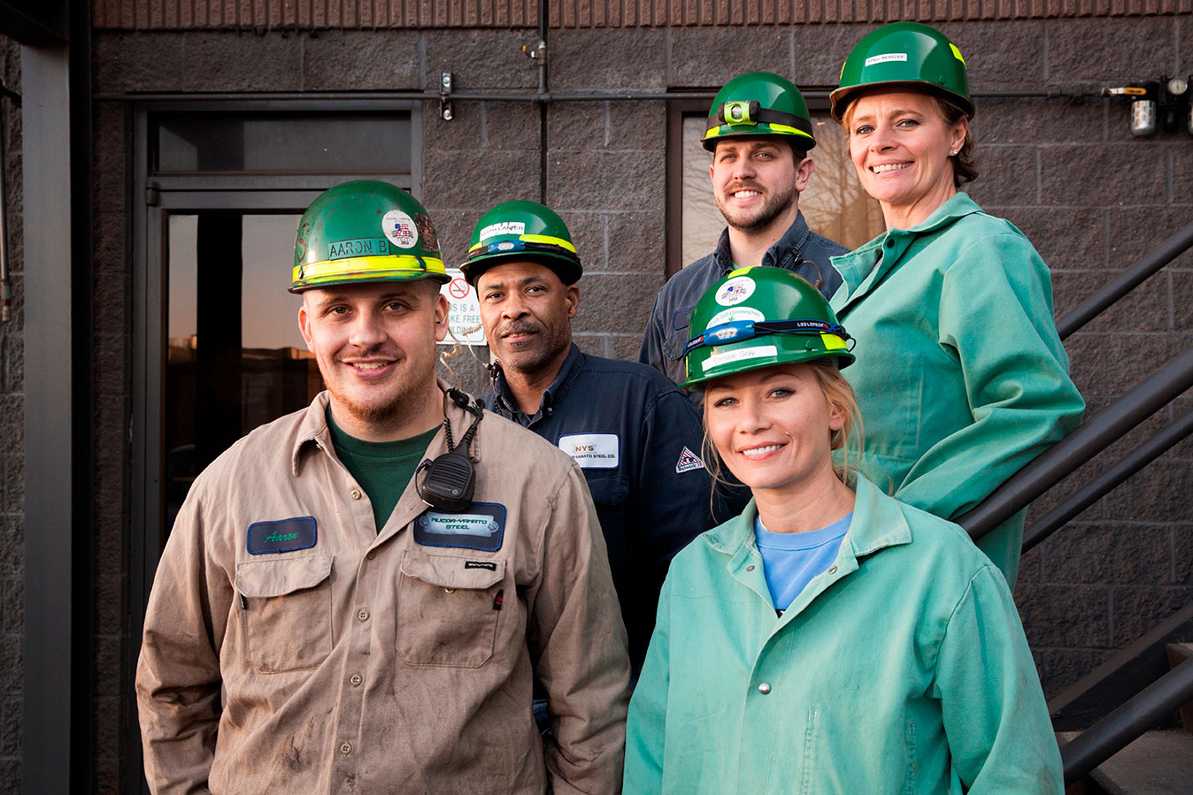 Photo of 5 Nucor teammates standing next to each other and smiling