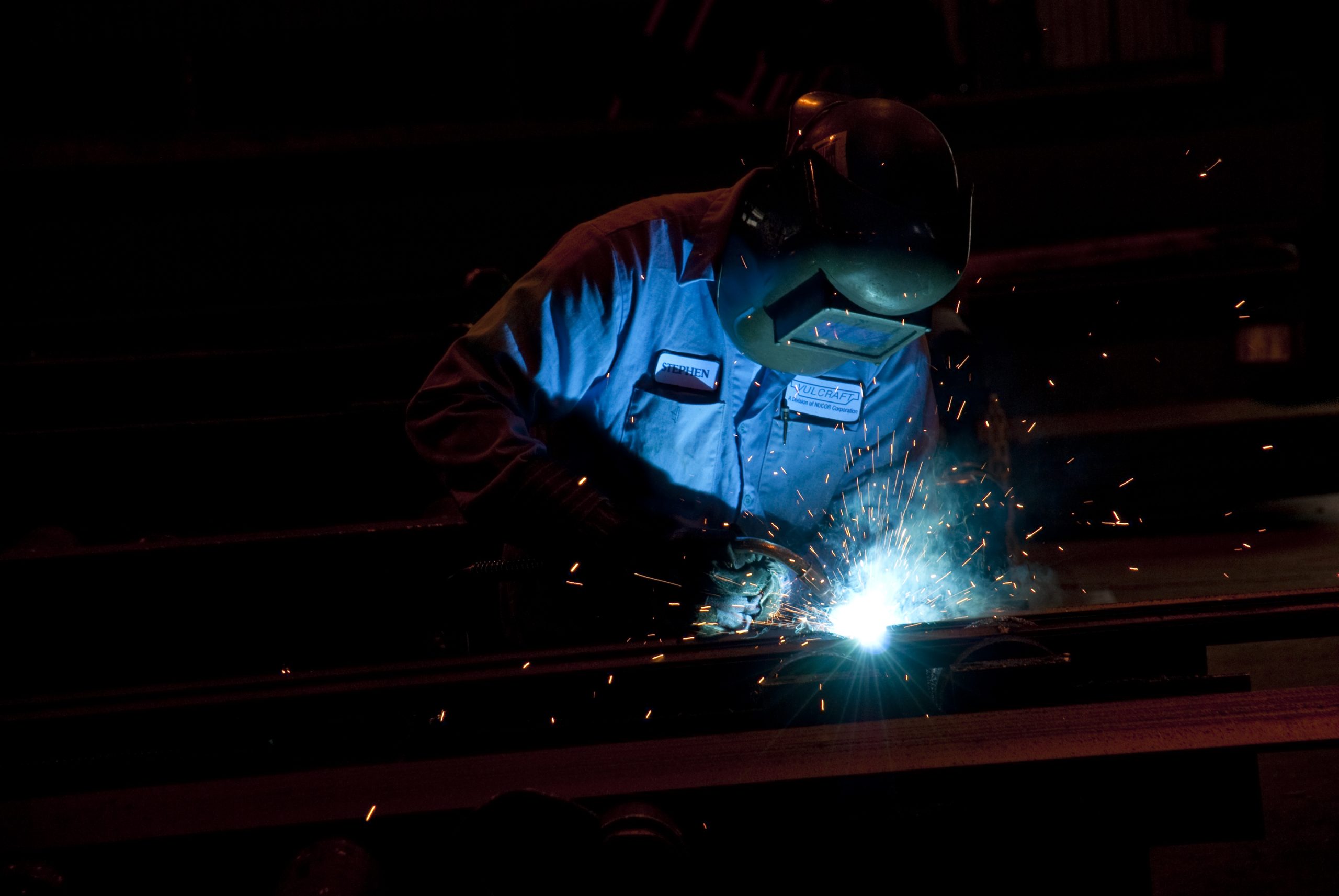 Photo of Nucor Vulcraft teammate welding a piece of Aeos beam