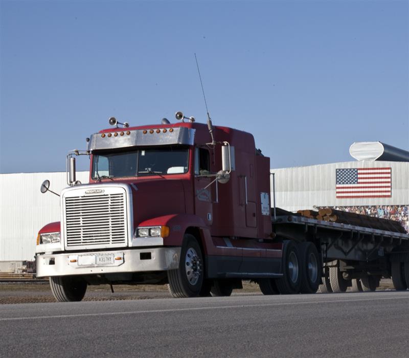 Photo of truck transporting Nucor steel from steel mill