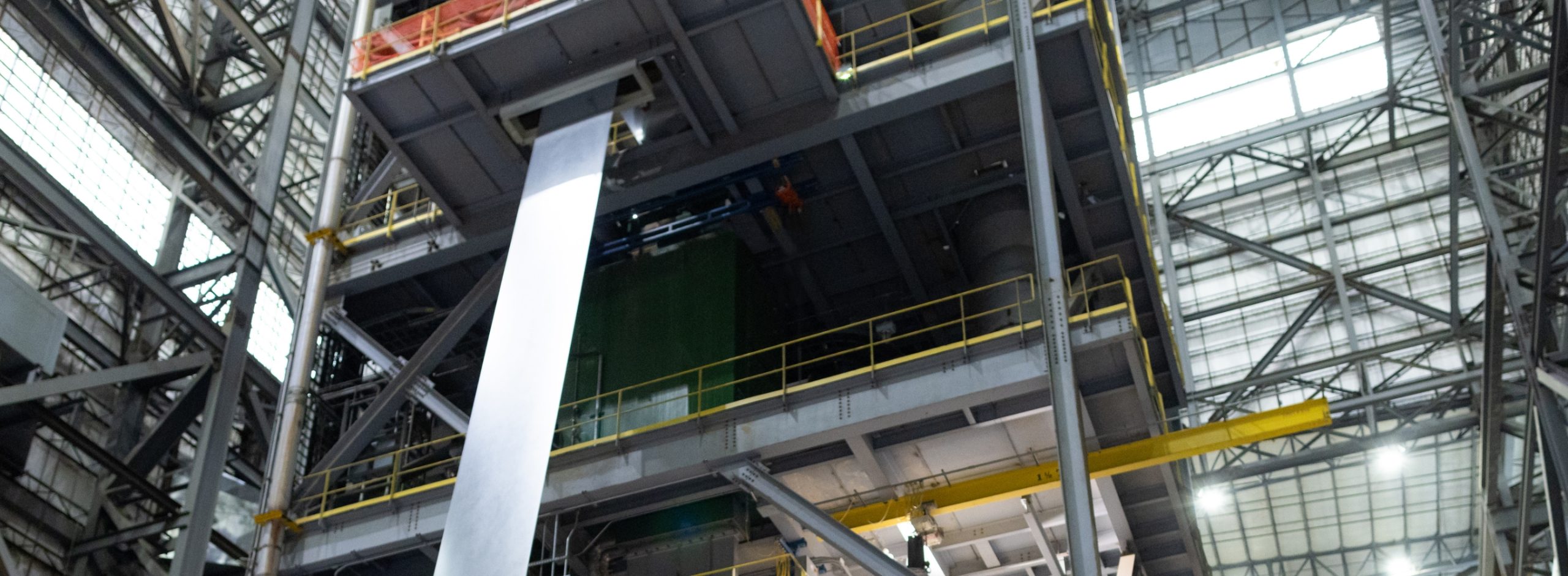 photo of nucor sheet steel being rolled out in a mill