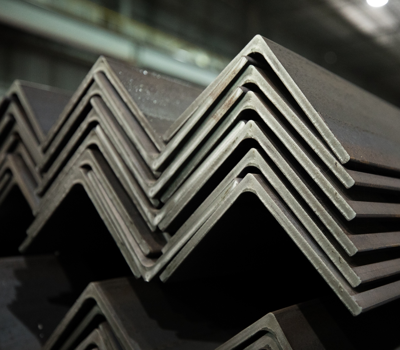 Photo of Nucor steel merchant bar angles stacked on top of one another